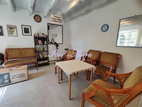 Living room with seating furniture, table and shelves. - image 2