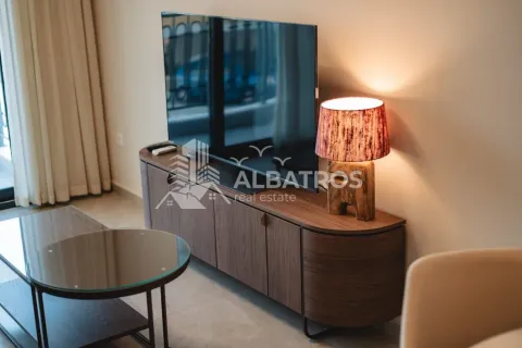 Living room with a television on a credenza and a decorative lamp. - image 7
