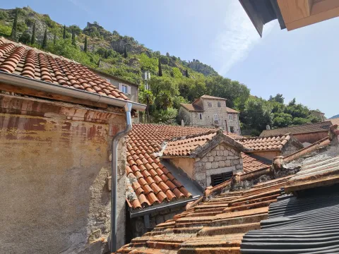 View from the terrace of old stone houses with red tile roofs and the surrounding hill. - image 5