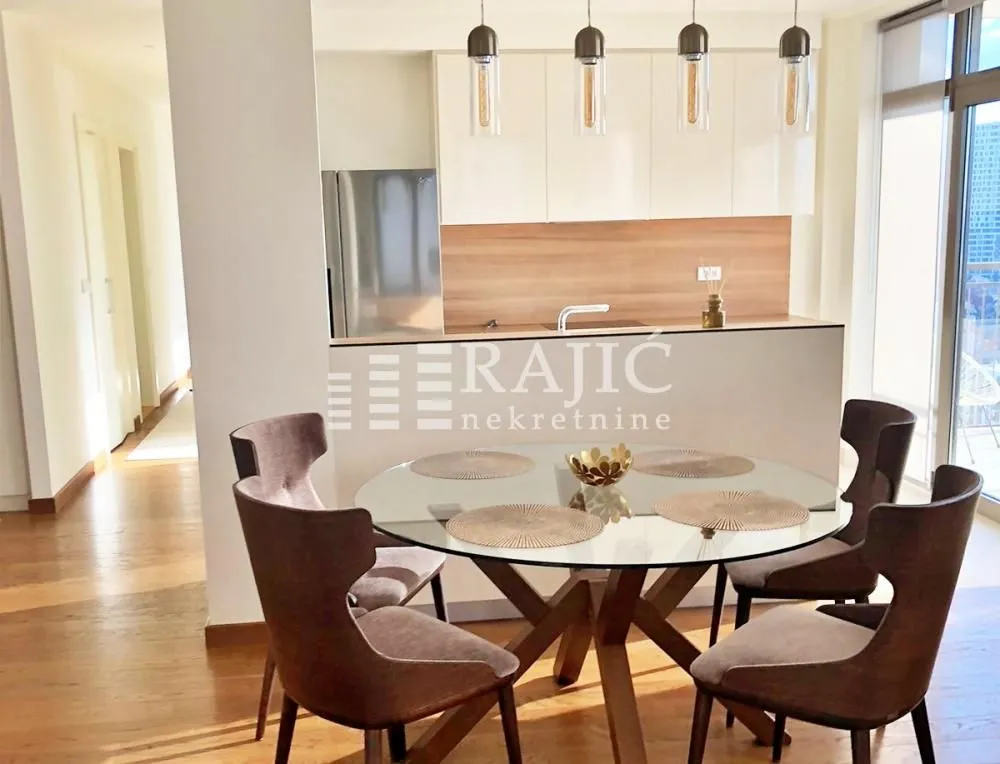 Modern kitchen with dining area and built-in appliances.