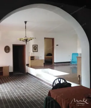 Living room with tiled floor and an arch dividing the space. - image 8