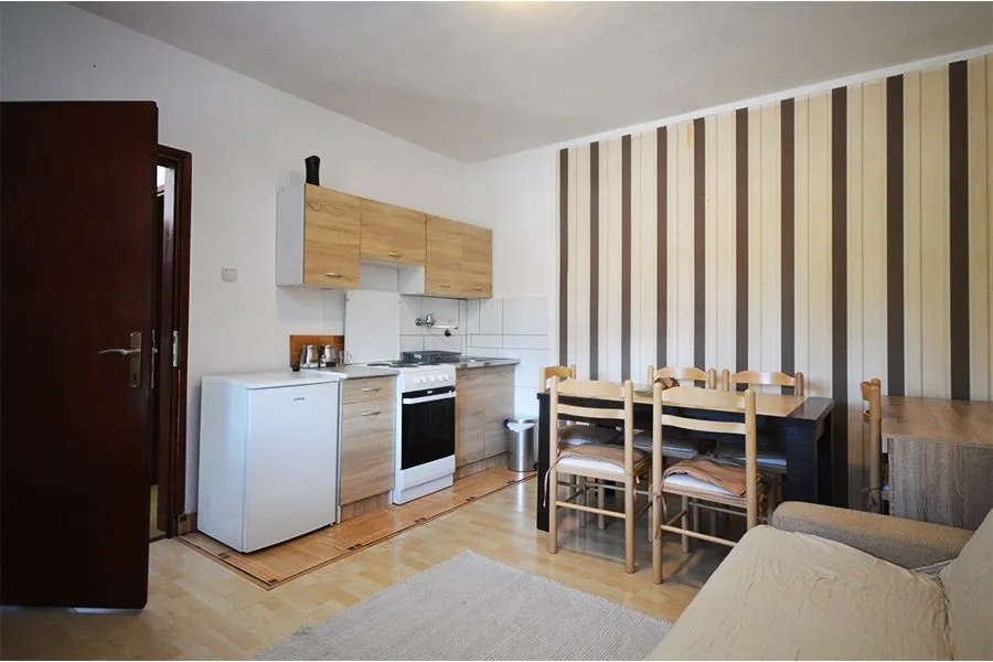 Small kitchen with a dining table and chairs.