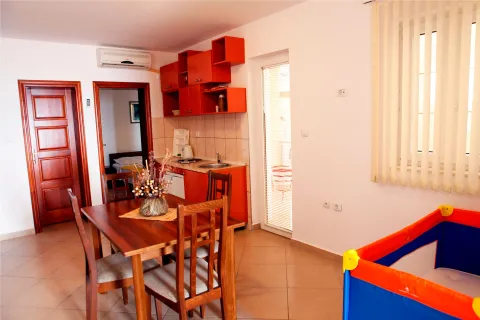 Dining area with kitchen and a view of the apartment interior. - image 3