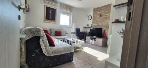 Living room with a sofa, TV, and a desk. - image 20