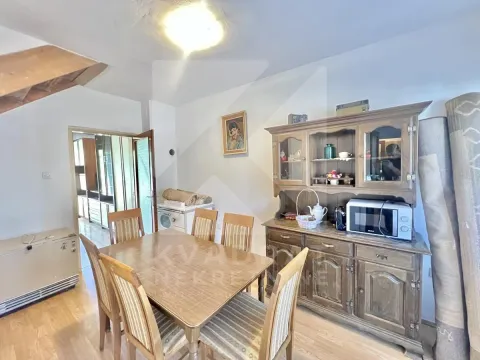 Dining room with a wooden table, chairs, and a large display cabinet. - image 5