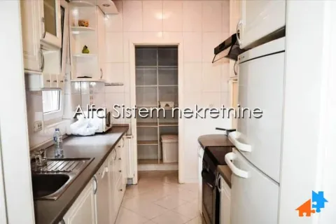 Compact kitchen with white cabinets and a pantry in the back. - image 8