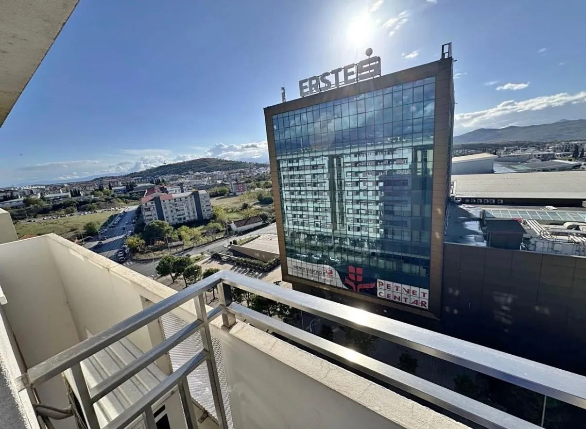 View from the balcony of the city and surrounding buildings.
