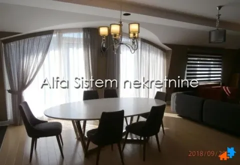 Spacious living room with a dining table and large windows. - image 4