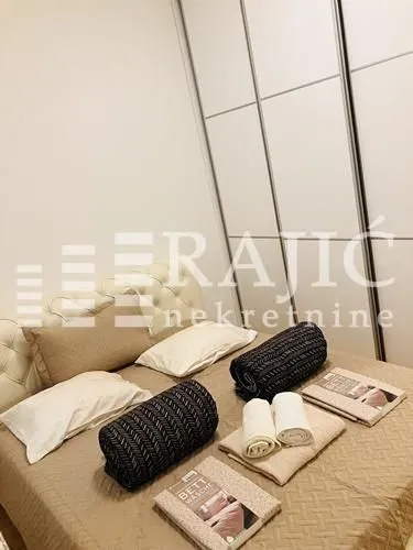 Furnished bedroom with a double bed and built-in wardrobe.