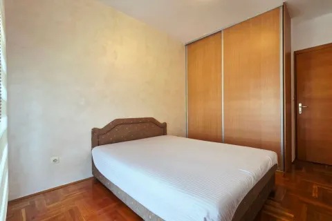 Bedroom with a double bed, large wooden wardrobe, and parquet flooring. - image 3