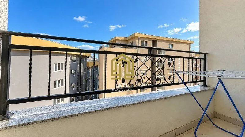 View from the terrace facing surrounding buildings and blue sky.