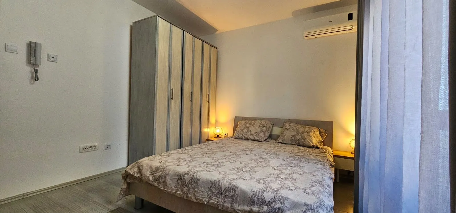 Furnished bedroom with a double bed and wardrobe.