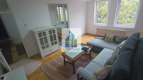 Living room with a sofa, coffee table, and white chest of drawers. - image 3