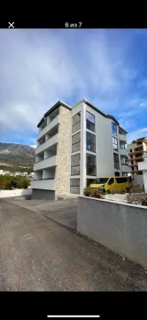 Exterior of a modern residential building with a courtyard. - image 6