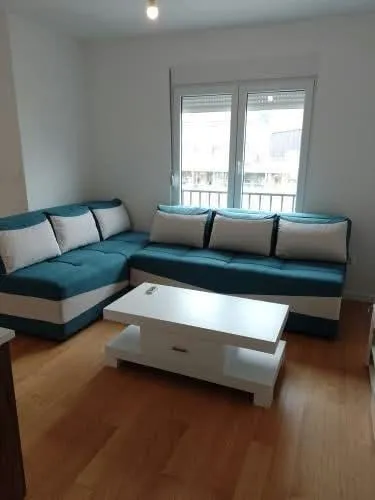 Living room with a sectional sofa and a white coffee table.