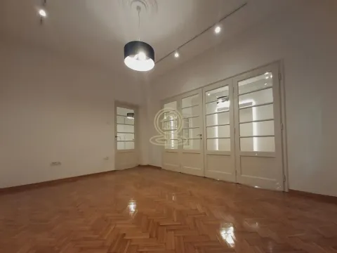 Empty room with parquet flooring and white wooden doors. - image 5