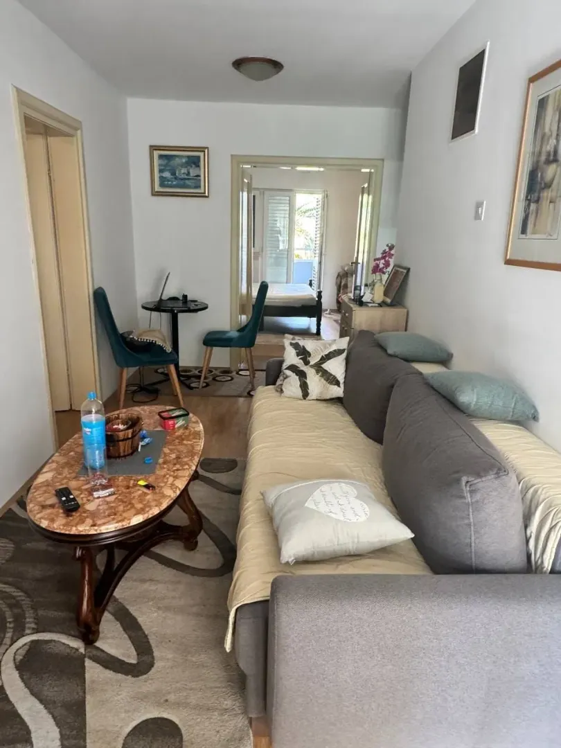 Living room with a sofa and a dining table.