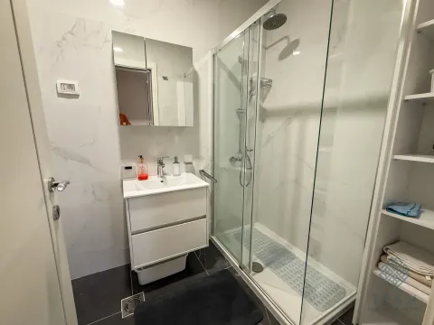 Modernly equipped bathroom with a shower cabin and a sink. - image 14