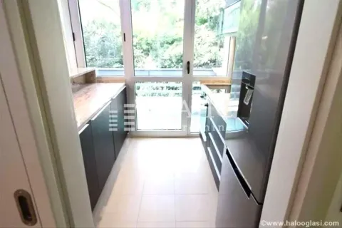 Small narrow kitchen with dark cabinets and access to the terrace. - image 2