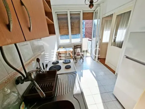 Smaller kitchen with a sink, stove, and access to the terrace. - image 4