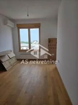 Empty room with wooden flooring, an air conditioning unit and a window. - image 4
