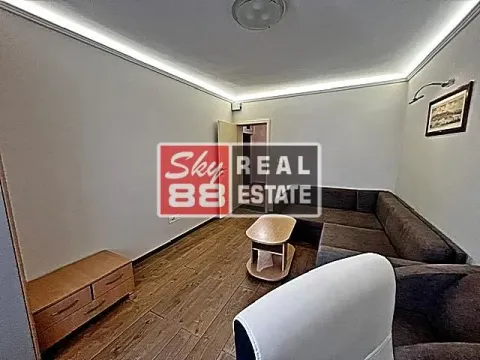 Living room with sofa, coffee table, and TV unit. - image 4