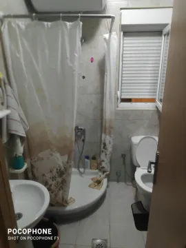A simple bathroom with a shower cabin and a toilet. - image 6