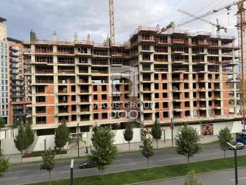 View of a multi-story building under construction with cranes in the background. - image 13