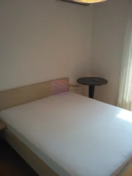 Bedroom with a double bed and a small side table. - image 8