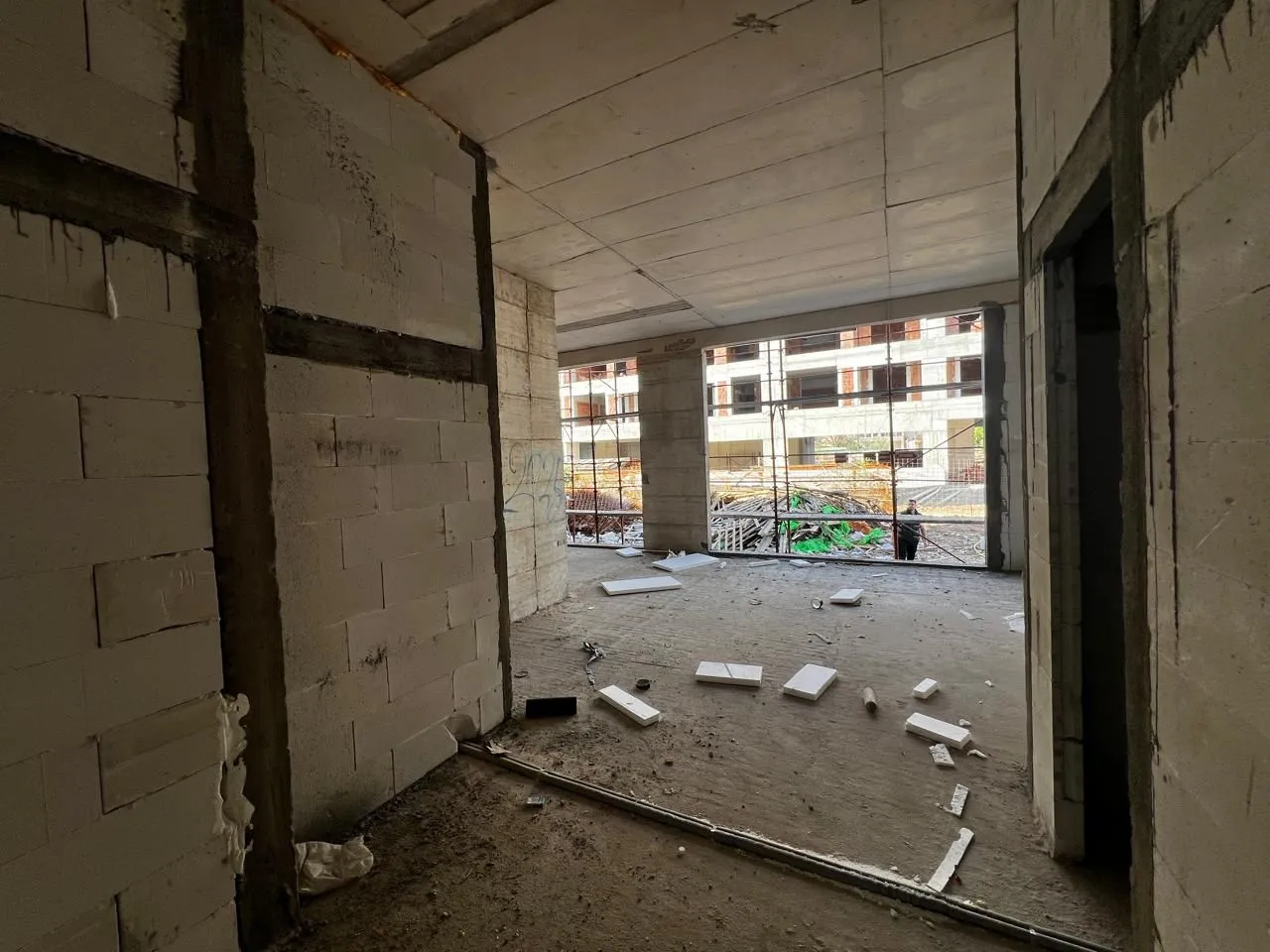 View from the interior of a building under construction with rough work and window openings.