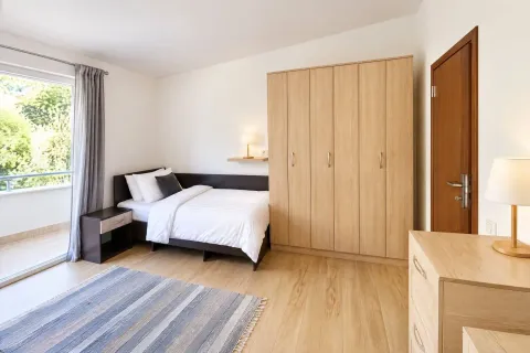 Furnished bedroom with a double bed, wardrobe, and access to the terrace. - image 13