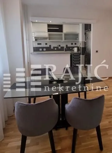 Dining area with a table and chairs, overlooking the kitchen.