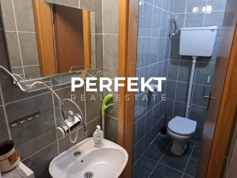 Smaller tiled bathroom with a sink and a toilet. - image 7