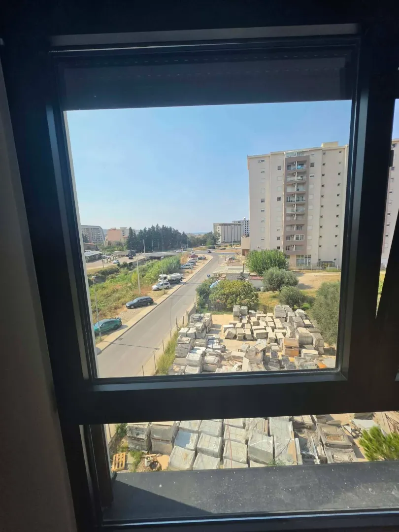 View through the window of the surrounding buildings and street.