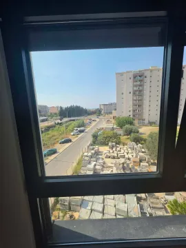 View through the window of the surrounding buildings and street. - image 11