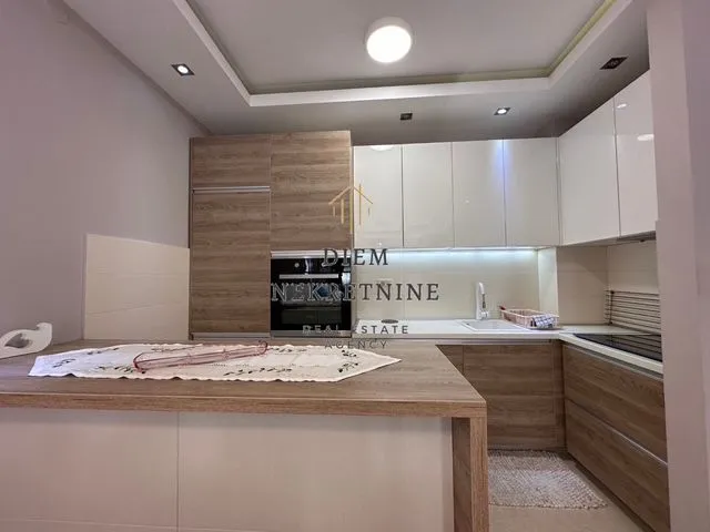 Modern kitchen with wooden elements and a countertop.