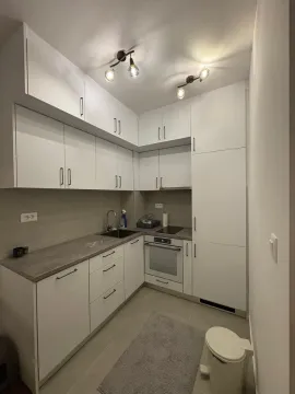 Modern white kitchen with built-in appliances. - image 3