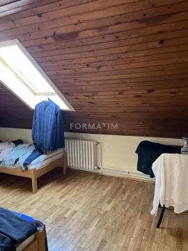 Attic bedroom with wooden ceiling, bed, and skylight. - image 2