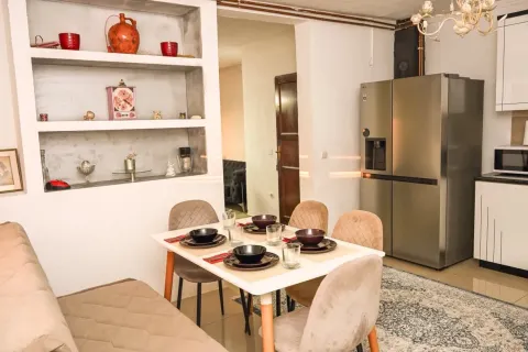 Dining area with a table and chairs, connected to the kitchen. - image 7