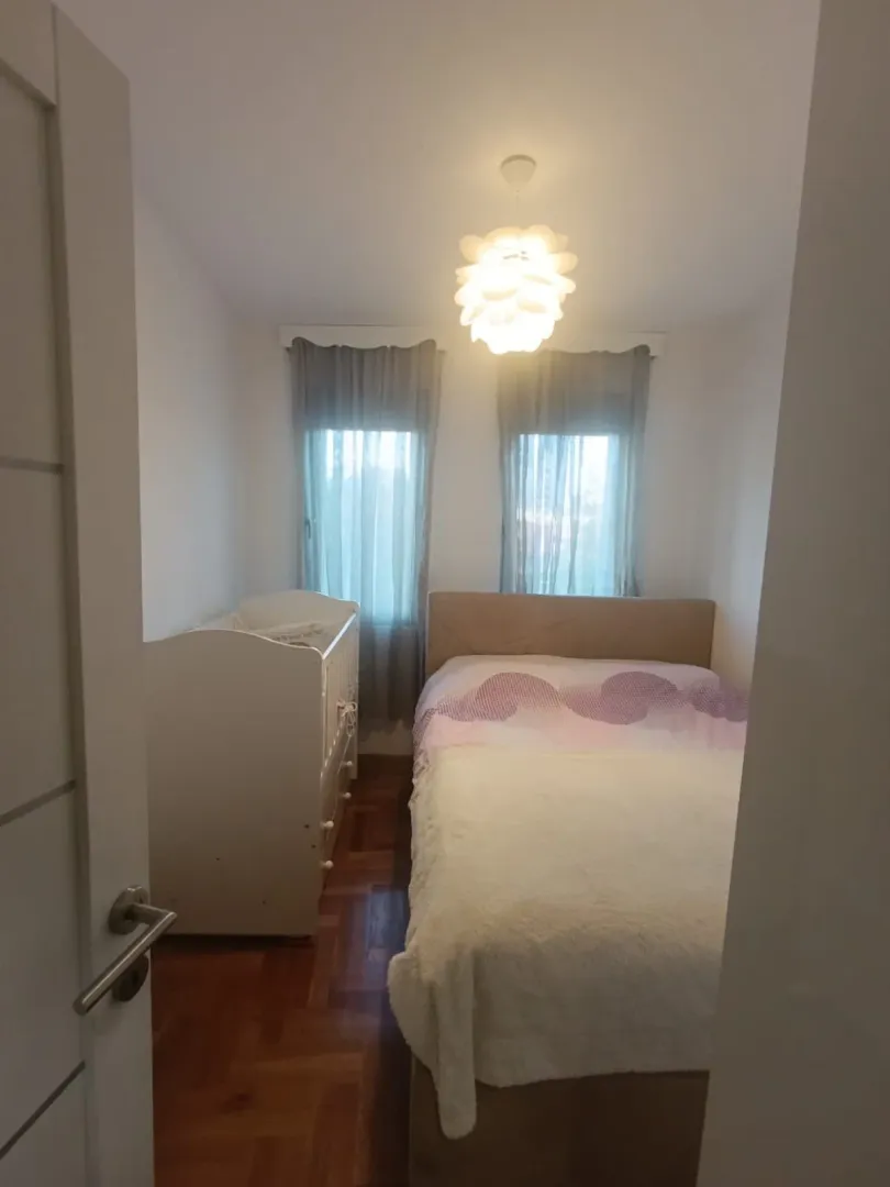Bedroom with a double bed and a baby crib.