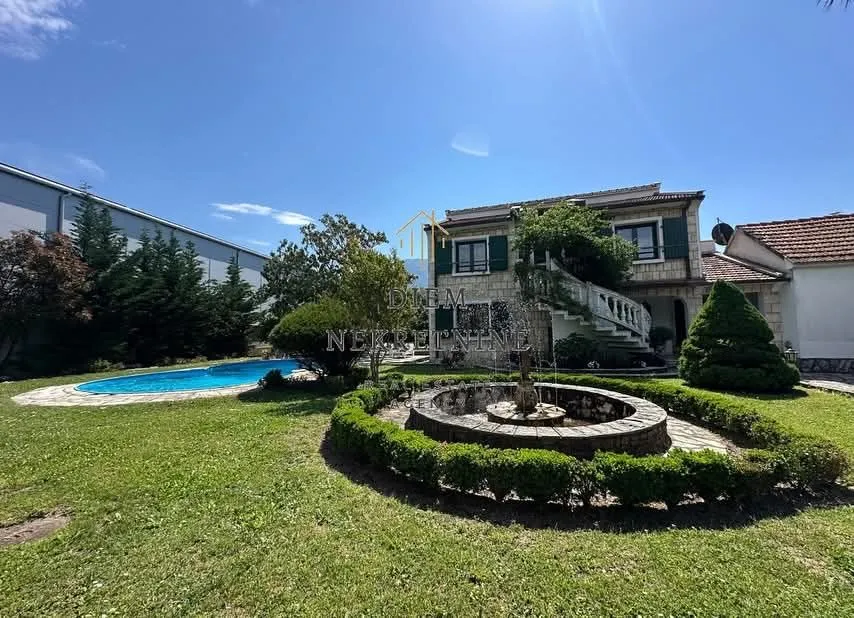 Exterior of the house with a yard, swimming pool, and fountain.