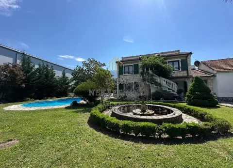 Exterior of the house with a yard, swimming pool, and fountain. - image 2