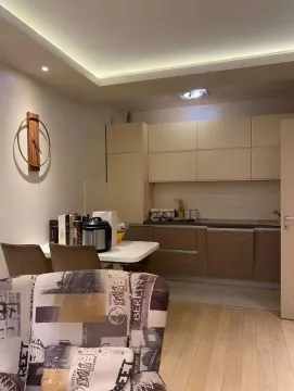 Kitchen with a dining area and part of the living room. - image 2