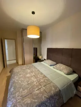Furnished bedroom with a double bed, wardrobe, and pendant lamp. - image 4
