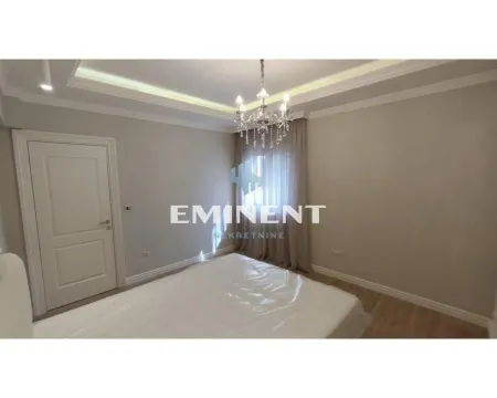 View of the bedroom with a bed and a dropped ceiling with lighting. - image 13