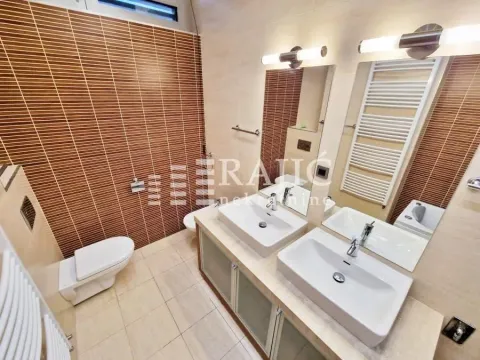 Modernly equipped bathroom with two washbasins and wall tiles. - image 6
