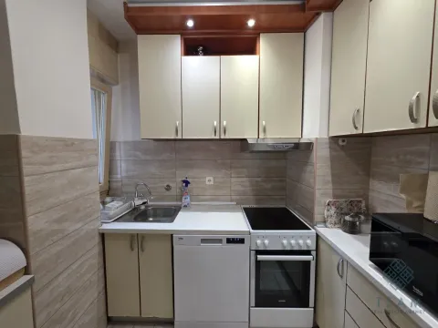 Compact equipped kitchen with a stove, sink, and dishwasher. - image 13