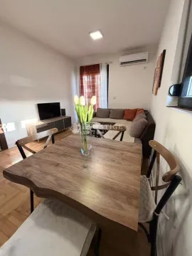Living room with a dining table and sofa set. - image 3