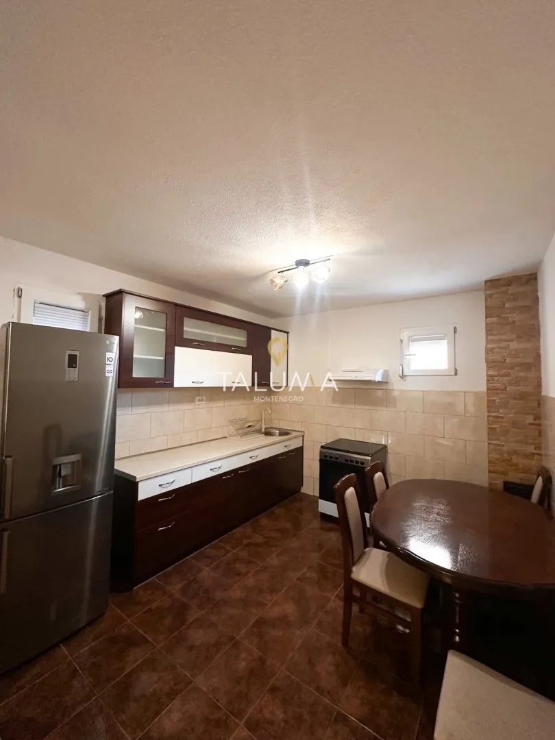 Kitchen with a dining area and dark wooden units.
