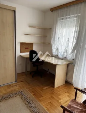 Small room with a desk, shelves, and a built-in wardrobe. - image 7